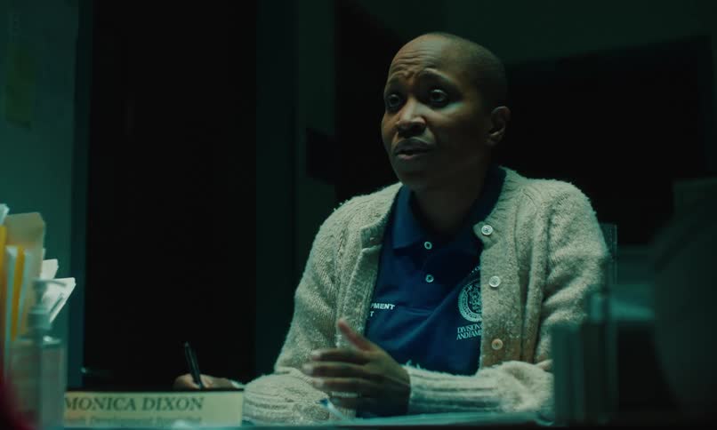 A woman is talking in her office