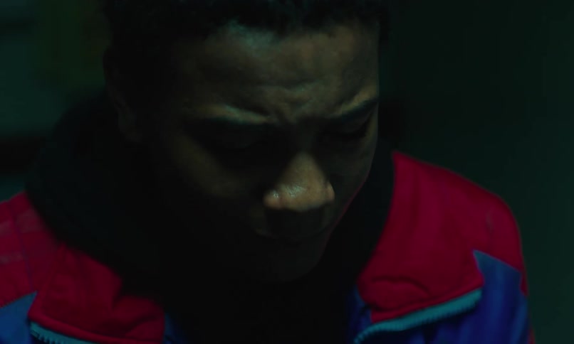 Teenager with a sad expression looking down