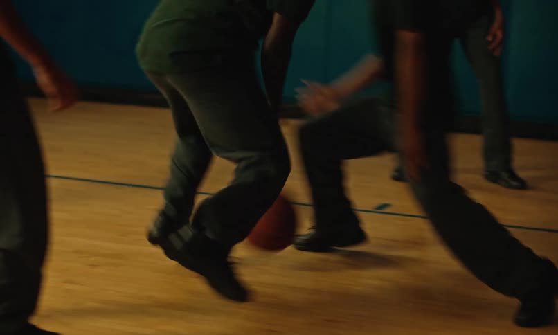 A group of men play basketball