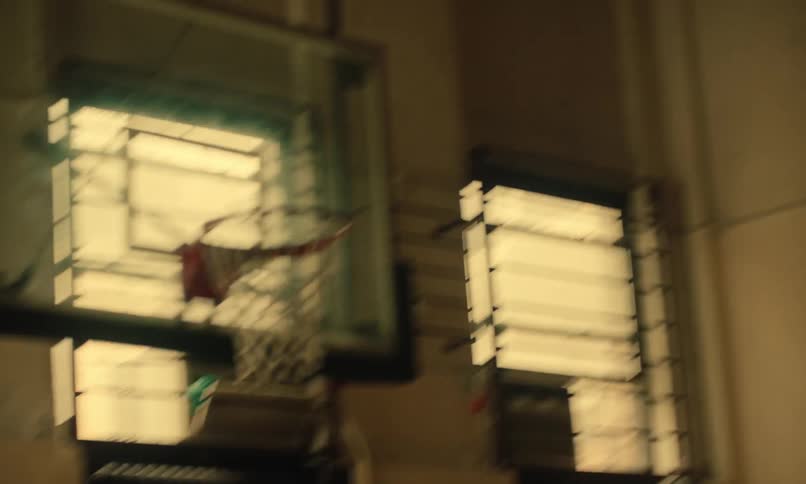 Young men playing basketball in the prison at the basketball court