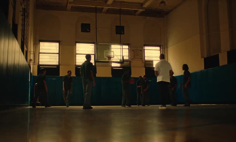 Youths play basketball in narrow gym