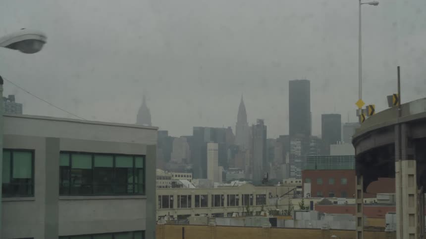 A cloudy day in new york city featuring many buildings and skyscrapers