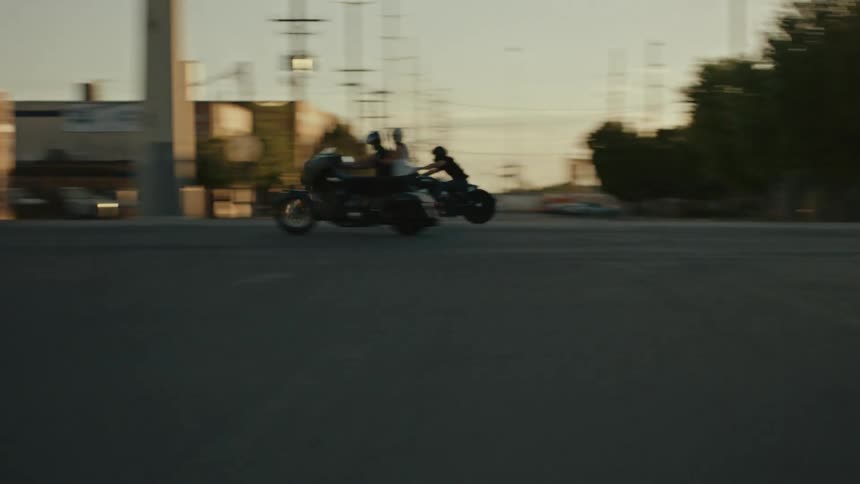 Motorcyclist racing down a city street
