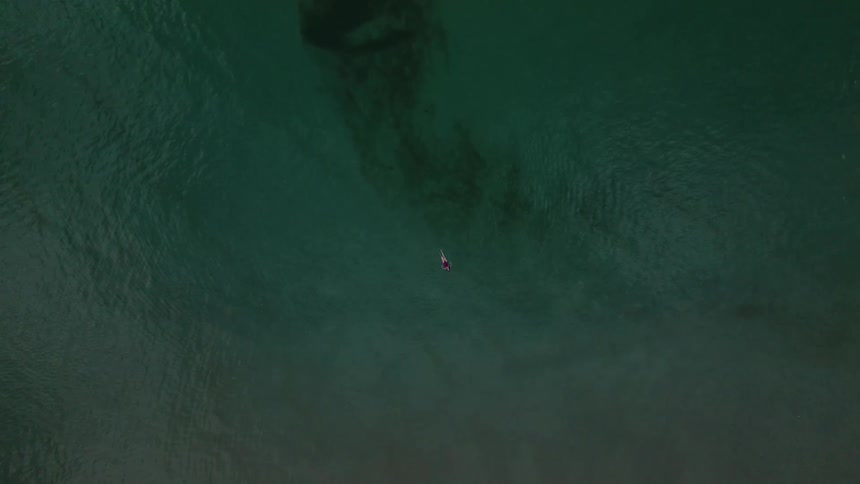 Birds eye view of a person swimming in the ocean