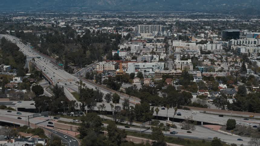 Traffic travels along the 101 Freeway during the day in Los Angeles