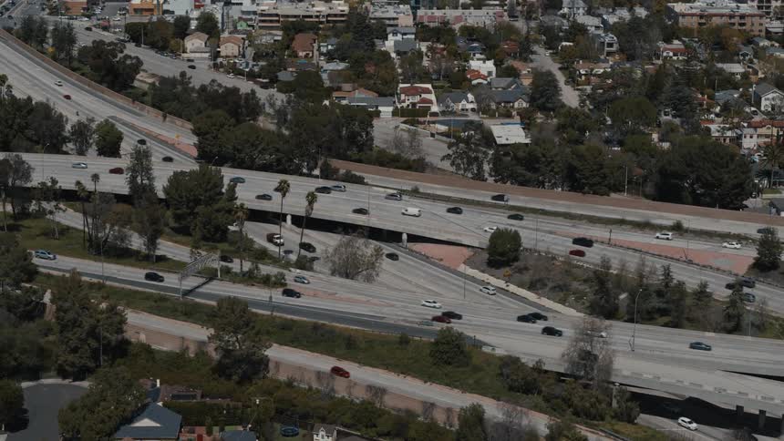 Aerial shot of traffic moving through a complex freeway interchange in Los Angeles