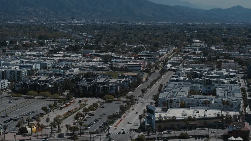 Aerial view of cars driving through a city during spring