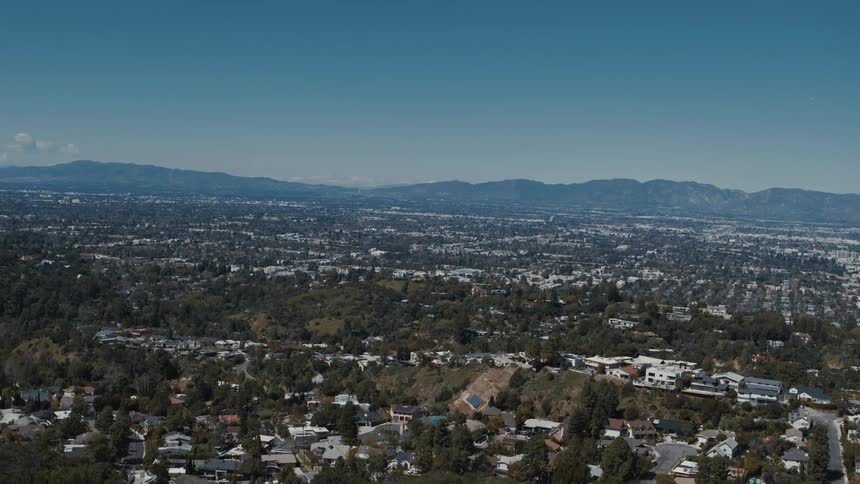 Wide view of a houses and in the distance rolling hills