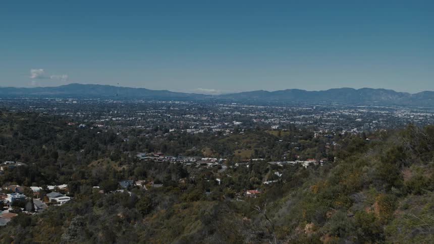An aerial view from the Hollywood Hills reveals the San Fernando Valley in the distance