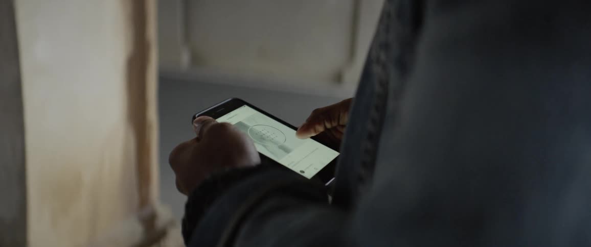A person uses a cell phone and scrolls down a page