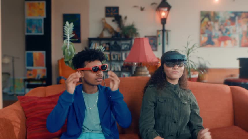 A male and a female put on virtual reality equipment and look at one another