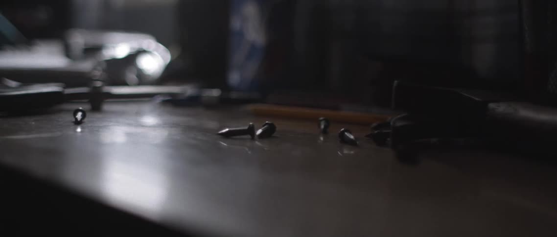 Screws are dumped out of bowl onto flat surface near window