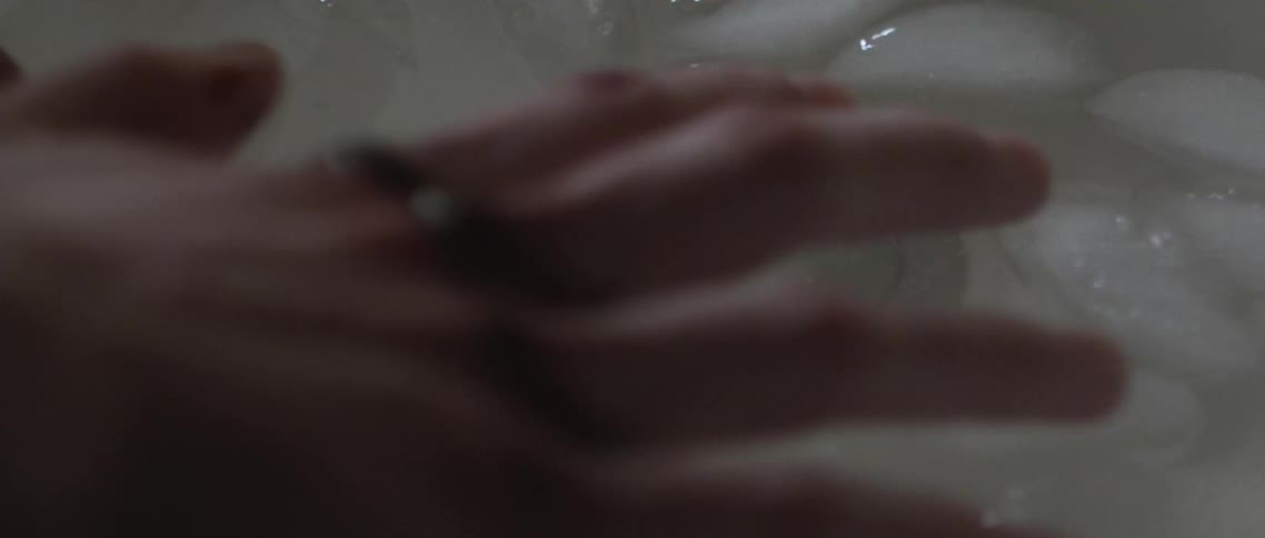 Close up of hands soaking in ice water in a sink