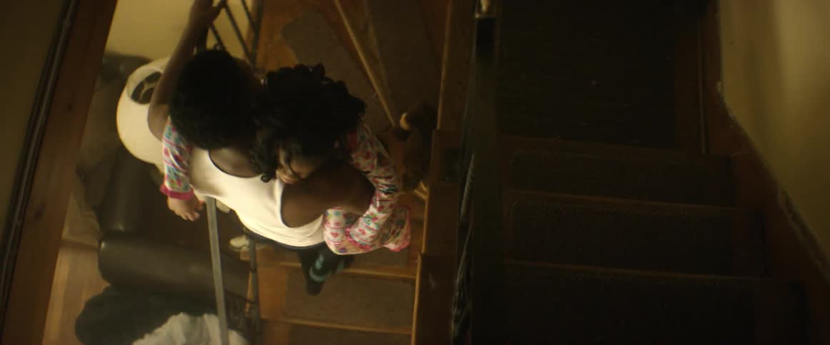 Man carries a little girl upstairs