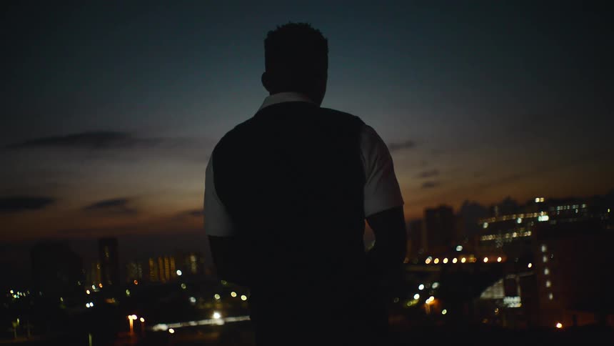 A man is standing outdoors and looking at the skyline