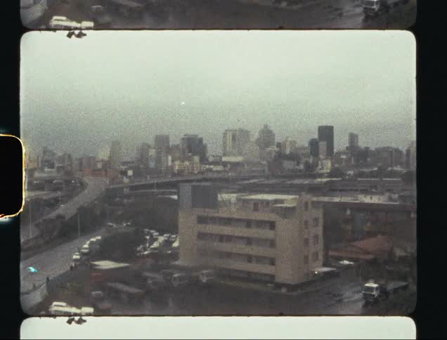Film footage of a downtown city is displayed