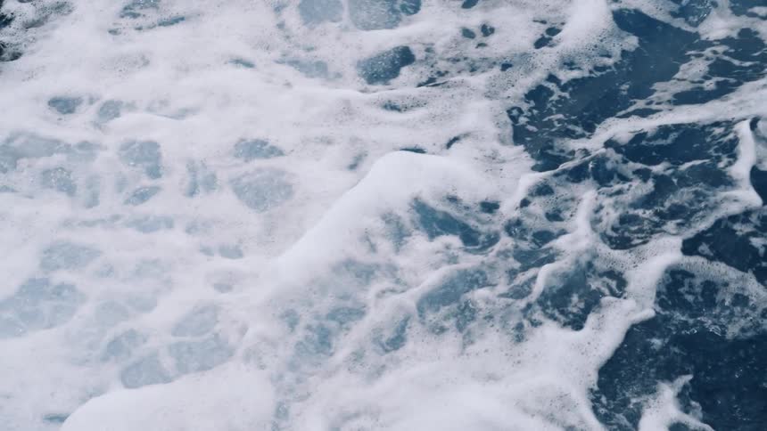 Agitated sea with small waves and foam