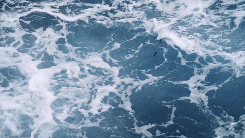 A turbulent sea with waves and foam