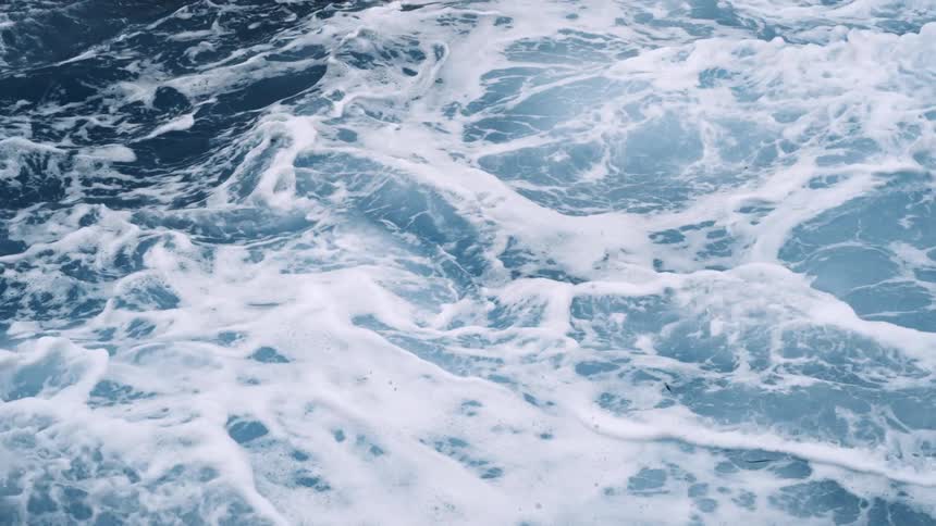 Coastal water churning roughly in the ocean