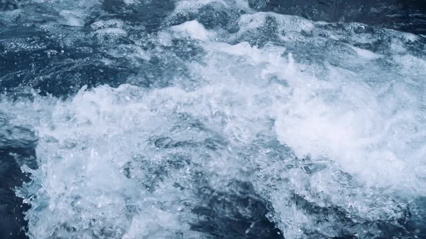 River water flows and churns creating foam