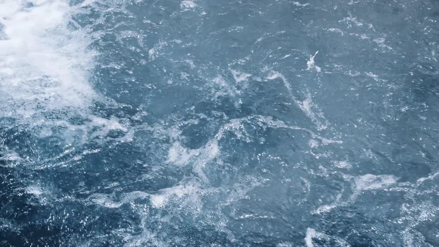 A still shot of running water like in a river creating splashes and foam