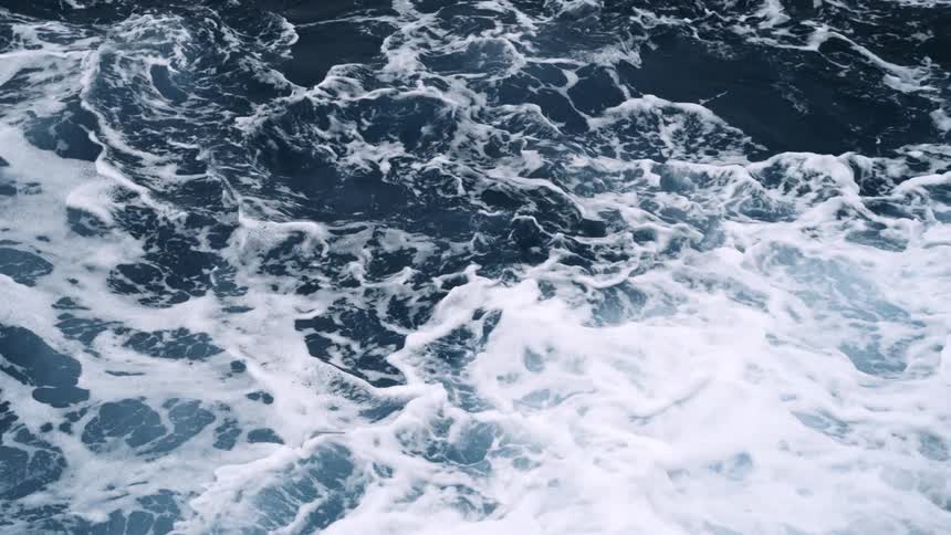 Slow motion view of ocean waves during midday