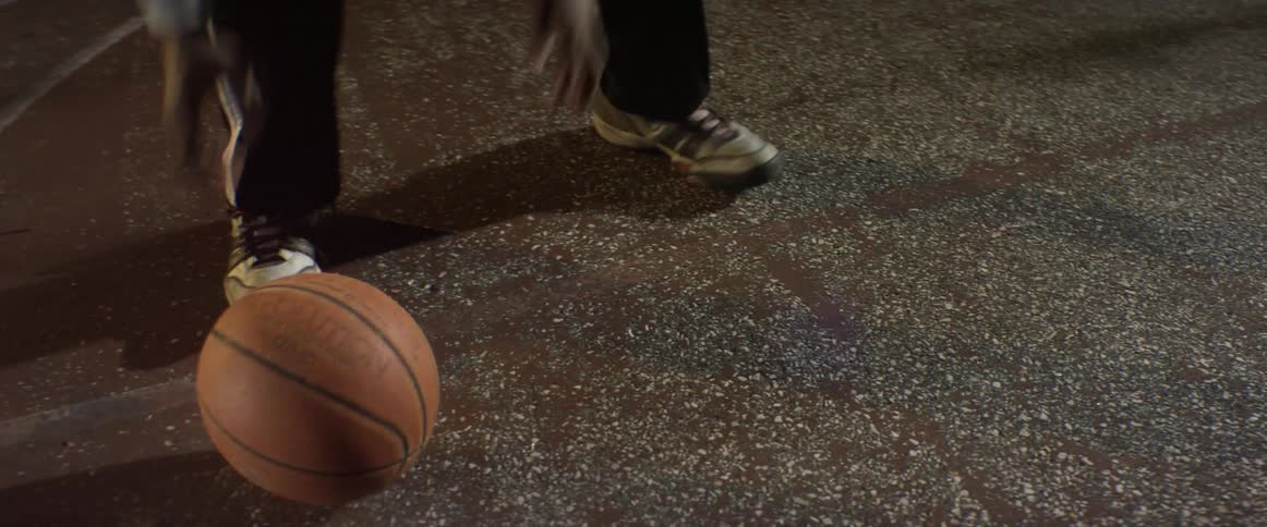 A man picks up a basketball