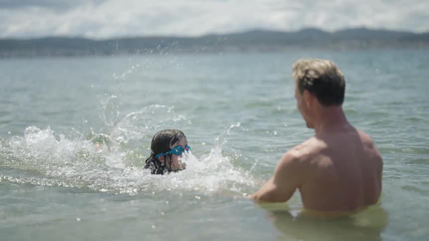 A father and daughter swimming