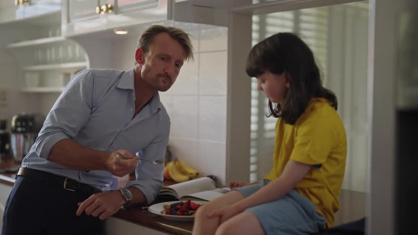 The view is of a portrait of a dad and child eating breakfast