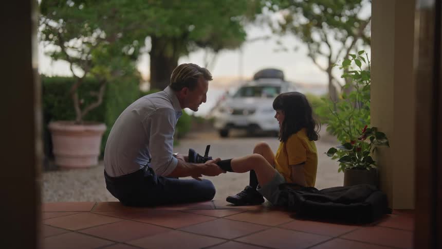 Father and daughter are outdoors in the day time