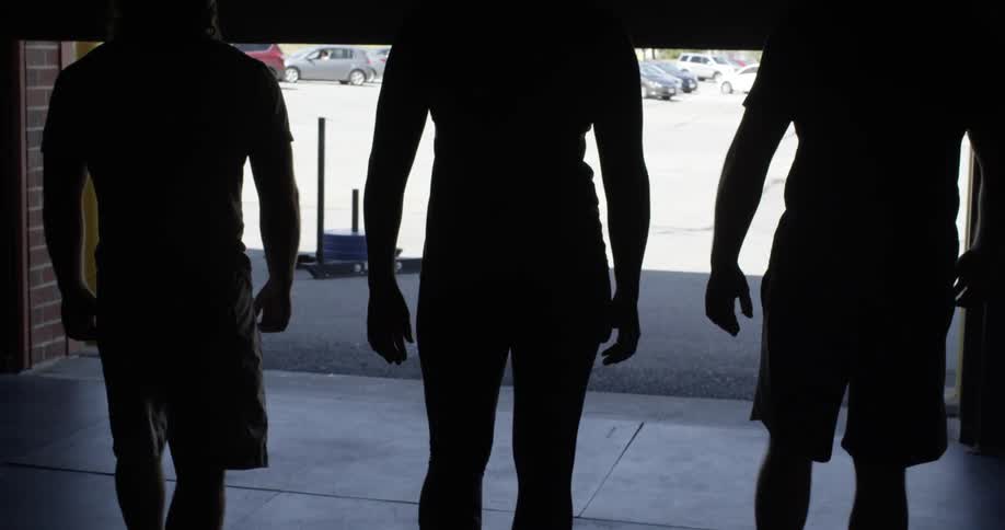 People walk together out of a dark garage