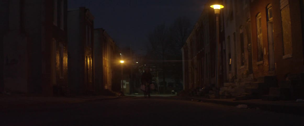 A person is traveling down a dark city street