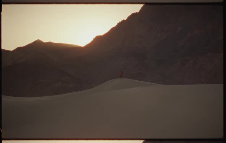 A view of sand dunes at sunrise