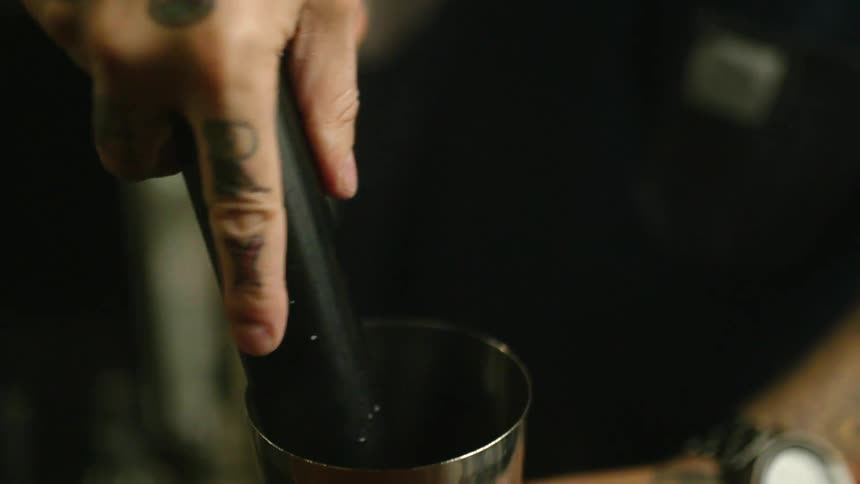 A man is making coffee and wearing a watch