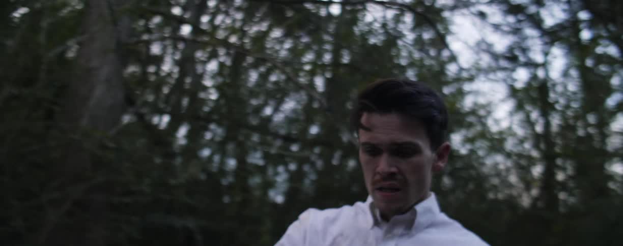 Man stands in the middle of the woods and runs away