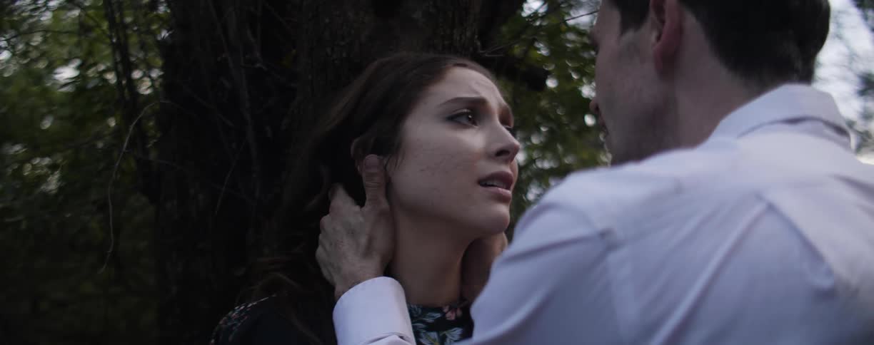 A man and woman embrace and talk