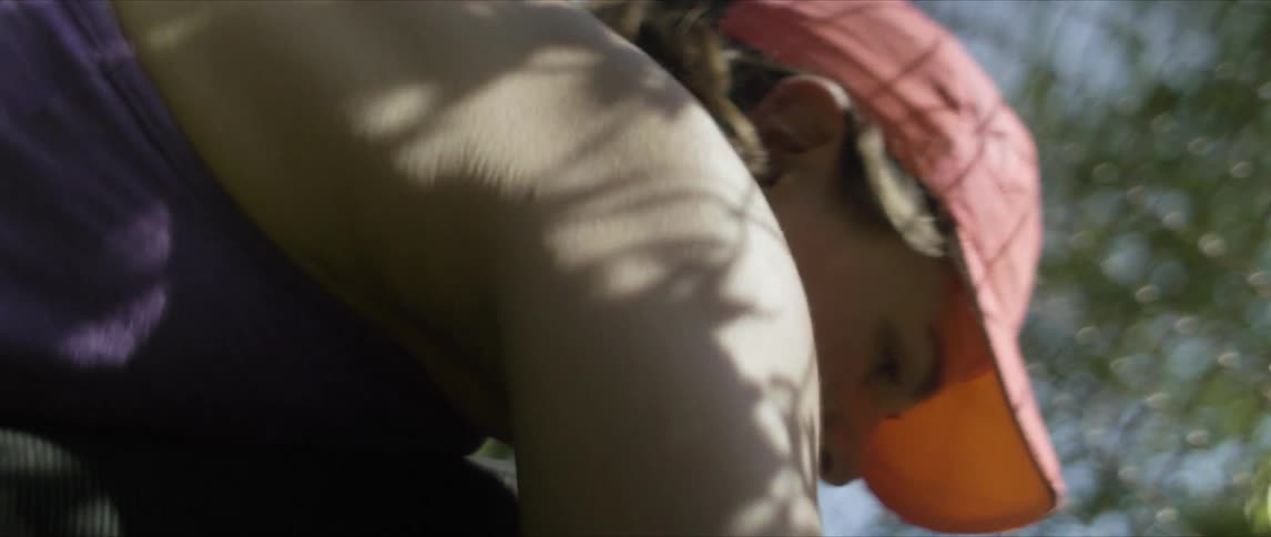 A woman digging around and placing or removing something from somewhere