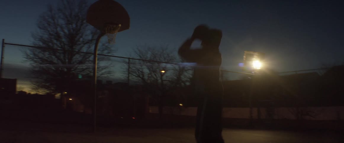 A man dribbles and then shoots a basketball