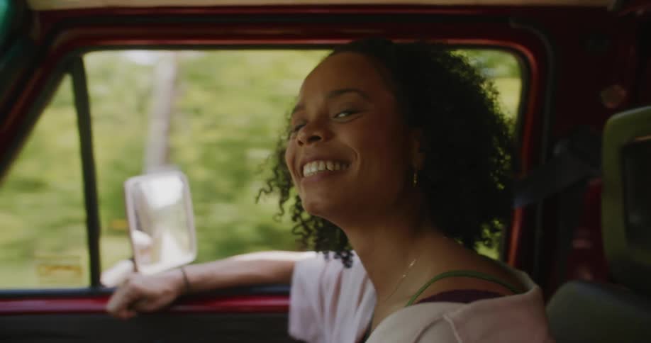 Smiling woman in a moving vehicle