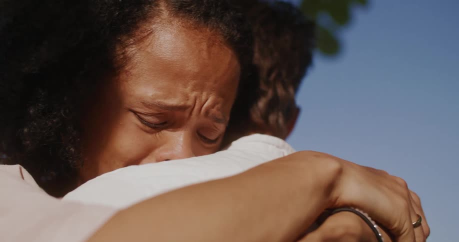 Woman hugs a man as shes about to start crying