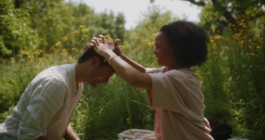 Loving couple wearing wreath in a forest