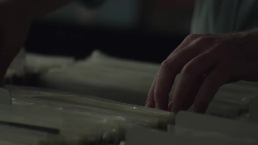 A person is flipping through records