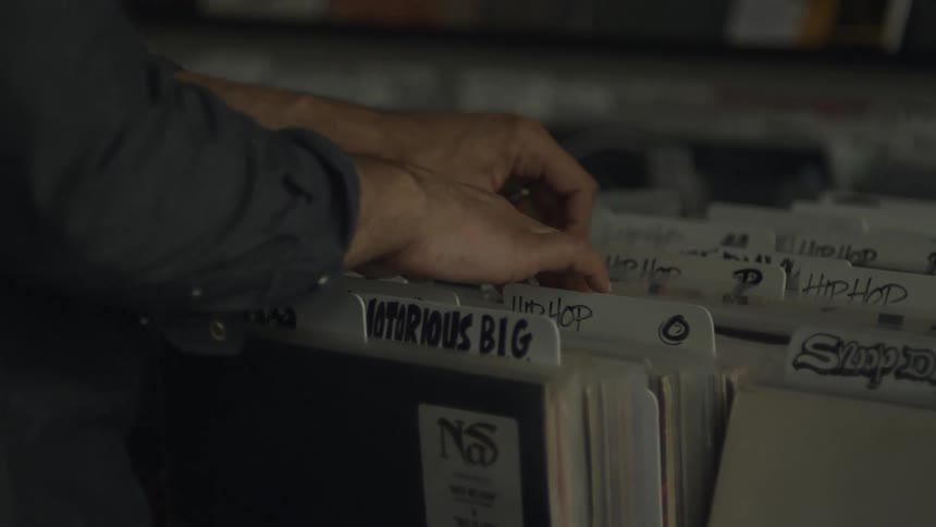 Customer browsers through albums at music store