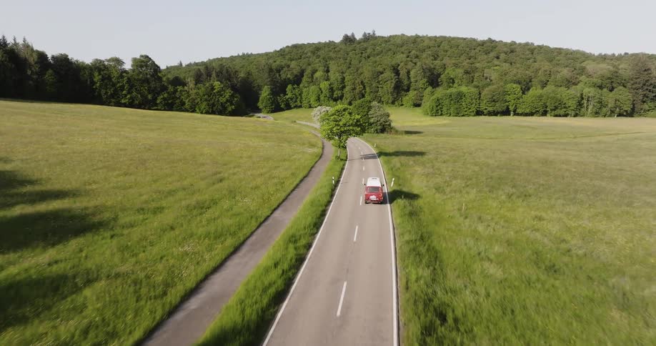 A car is driving through a rural area during the spring