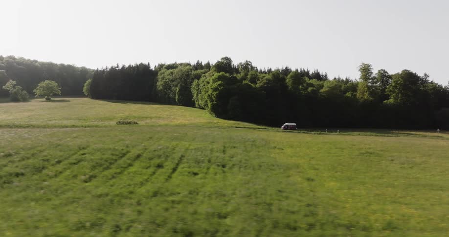 Vehicle on a road with natural landscape with forest and plain