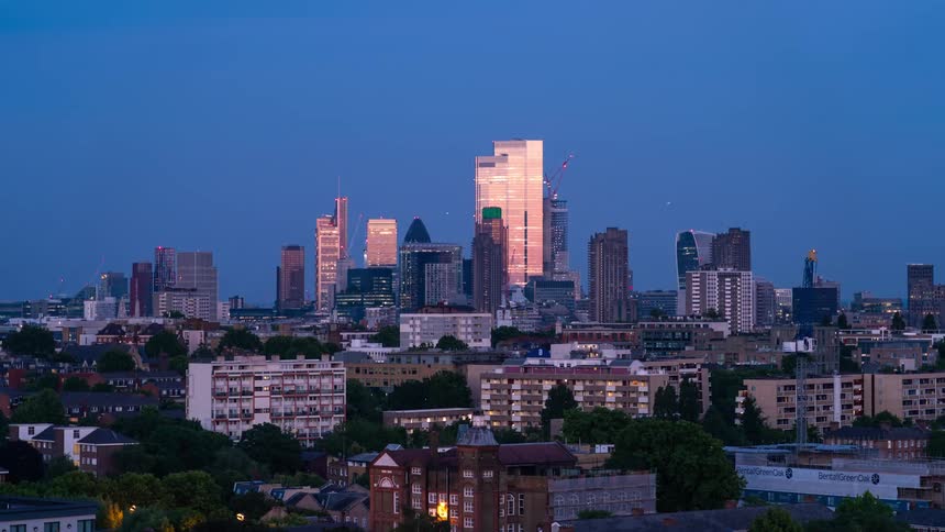 Time lapse view of the sun setting above a city