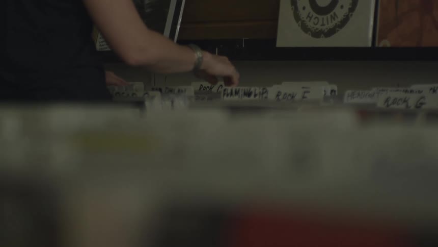 A person looking through tabbed files in a store