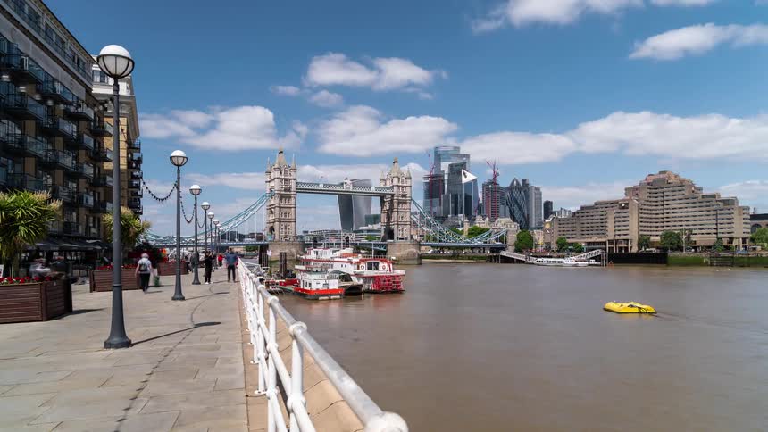 Pedestrians and boats travel through the city