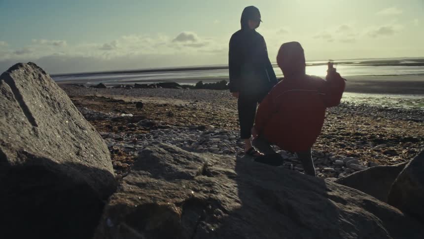 Mother and young child enjoy a sunny day on the beach