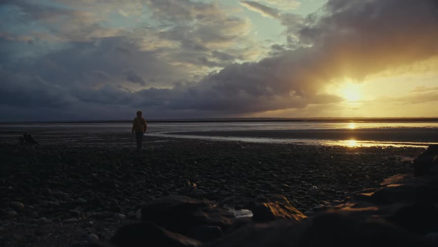 Photographer takes picture of the sunset on a beach